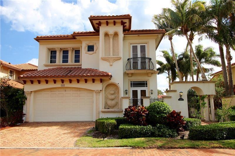 A two-story Mediterranean-style house features a tiled roof, a garage, and a small balcony — 580 Admirals Way, Delray Beach FL 33483, DELRAY BEACH, FL