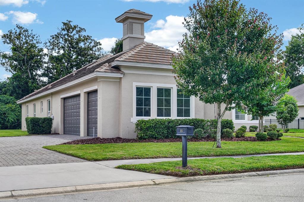 A beige house with a tiled roof, a cupola, and a two-car garage — 46 NEW LEATHERWOOD DRIVE, PALM COAST, FL