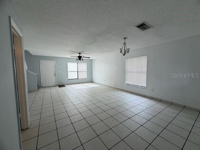 An empty living room features white walls, a tiled floor, and a ceiling fan — 1610 LITTLE RIVER DRIVE UNIT 20, ORLANDO, FL