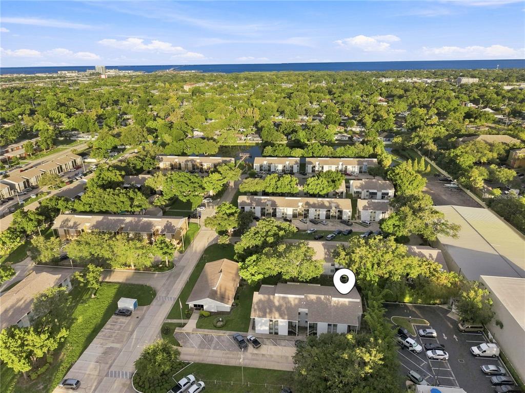 An aerial view shows a residential complex with multiple buildings, parking lots, and surrounding trees — 3807 N OAK DRIVE UNIT D41, TAMPA, FL