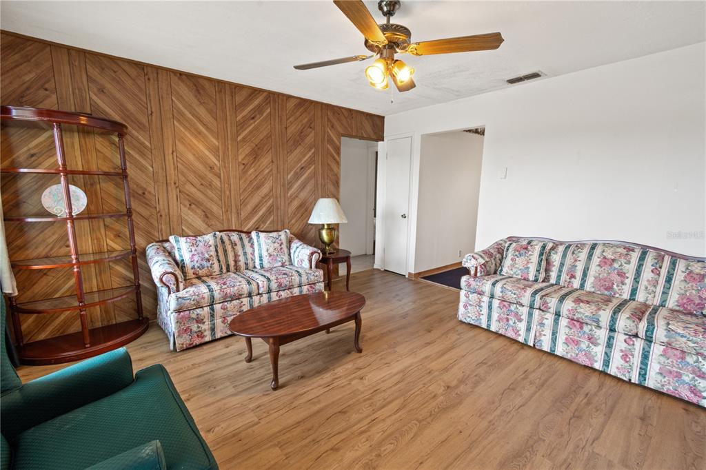 A kitchen features light wood cabinets, stainless steel appliances, and beige tile flooring — 245 ALTURAS ROAD, BARTOW, FL