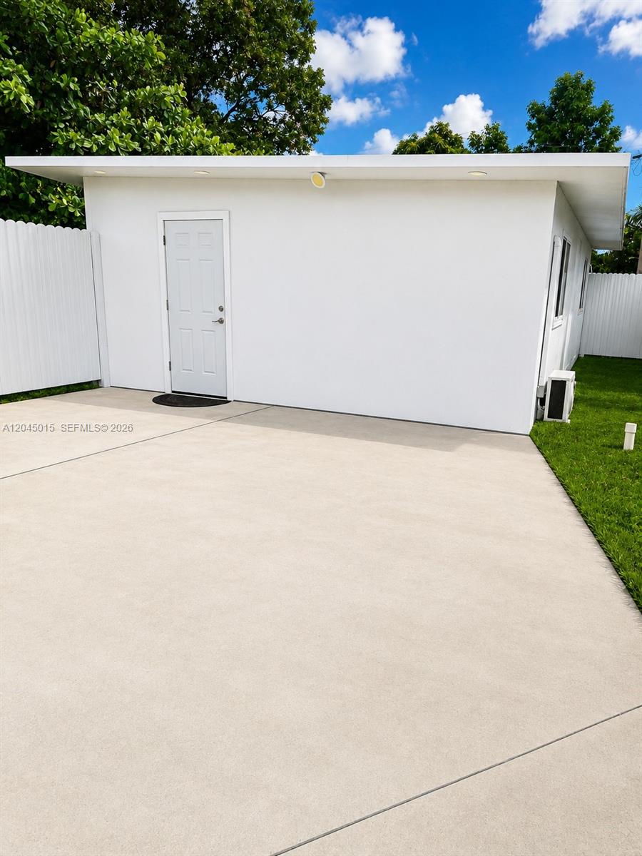 A white detached building features a single door and a concrete driveway — 23 Miami Gardens Rd # 3, West Park FL 33023, WEST PARK, FL