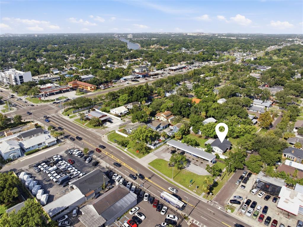 An aerial view shows a residential property marked with a pin in a suburban neighborhood — 106 W COMANCHE AVENUE, TAMPA, FL