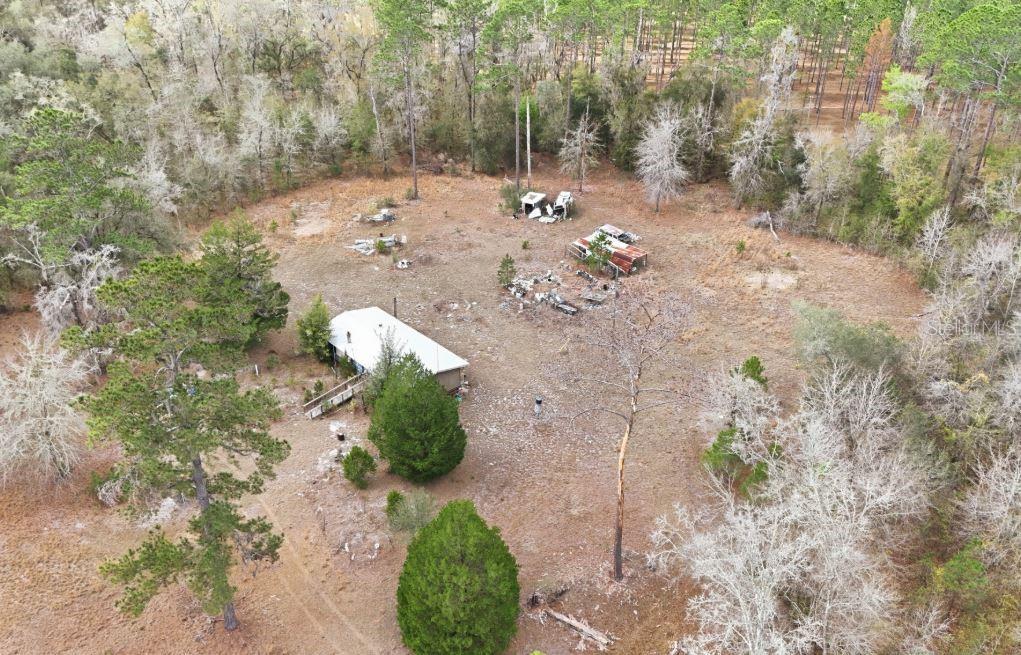 An aerial view shows a rectangular plot of land outlined in red near a road — 17828 NE 21ST STREET, GAINESVILLE, FL