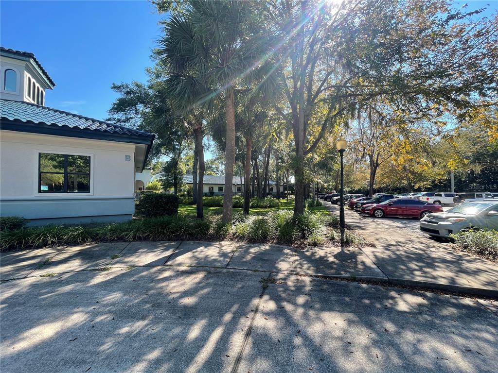 A view of a building exterior with a parking lot and trees — 4500 NW 27TH AVENUE UNIT B-2, GAINESVILLE, FL