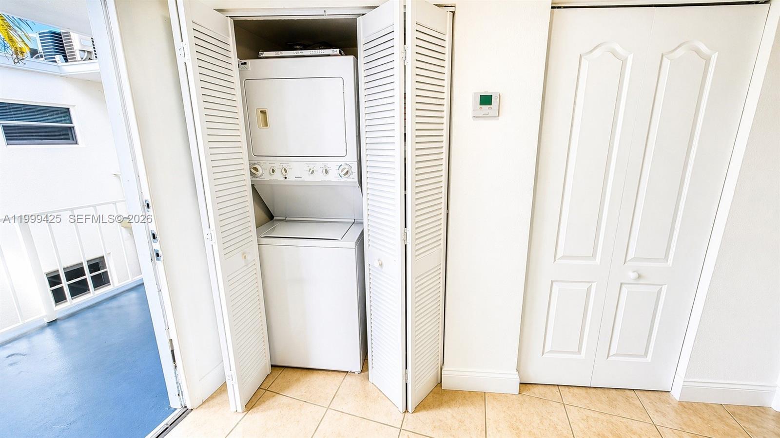 A kitchen features white appliances, light-colored cabinetry, beige countertops, and tiled flooring — 4255 N University Dr # 308, Sunrise FL 33351, SUNRISE, FL