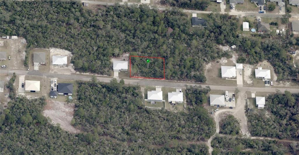 An aerial view shows a vacant, wooded residential lot outlined in red along a street — WALDOR AVENUE, ORANGE CITY, FL