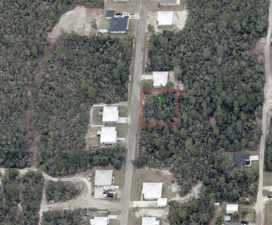 An aerial view shows a vacant, wooded residential lot outlined in red along a road — WALDOR AVENUE, ORANGE CITY, FL