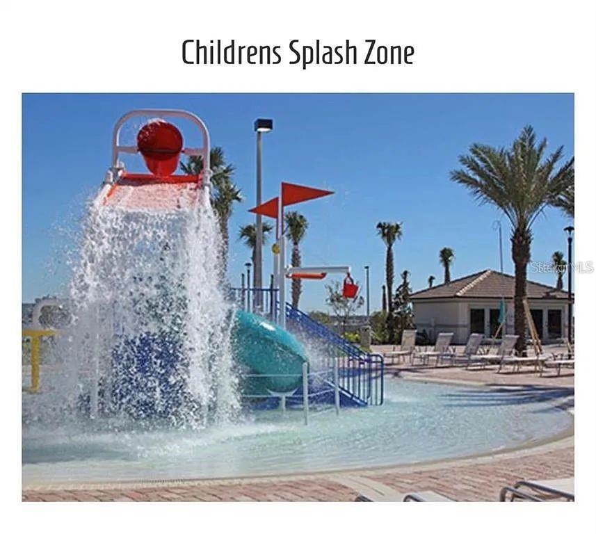 A children's splash zone features a large dumping bucket, a small slide, and palm trees — 811 OCEAN COURSE AVENUE UNIT 811, DAVENPORT, FL