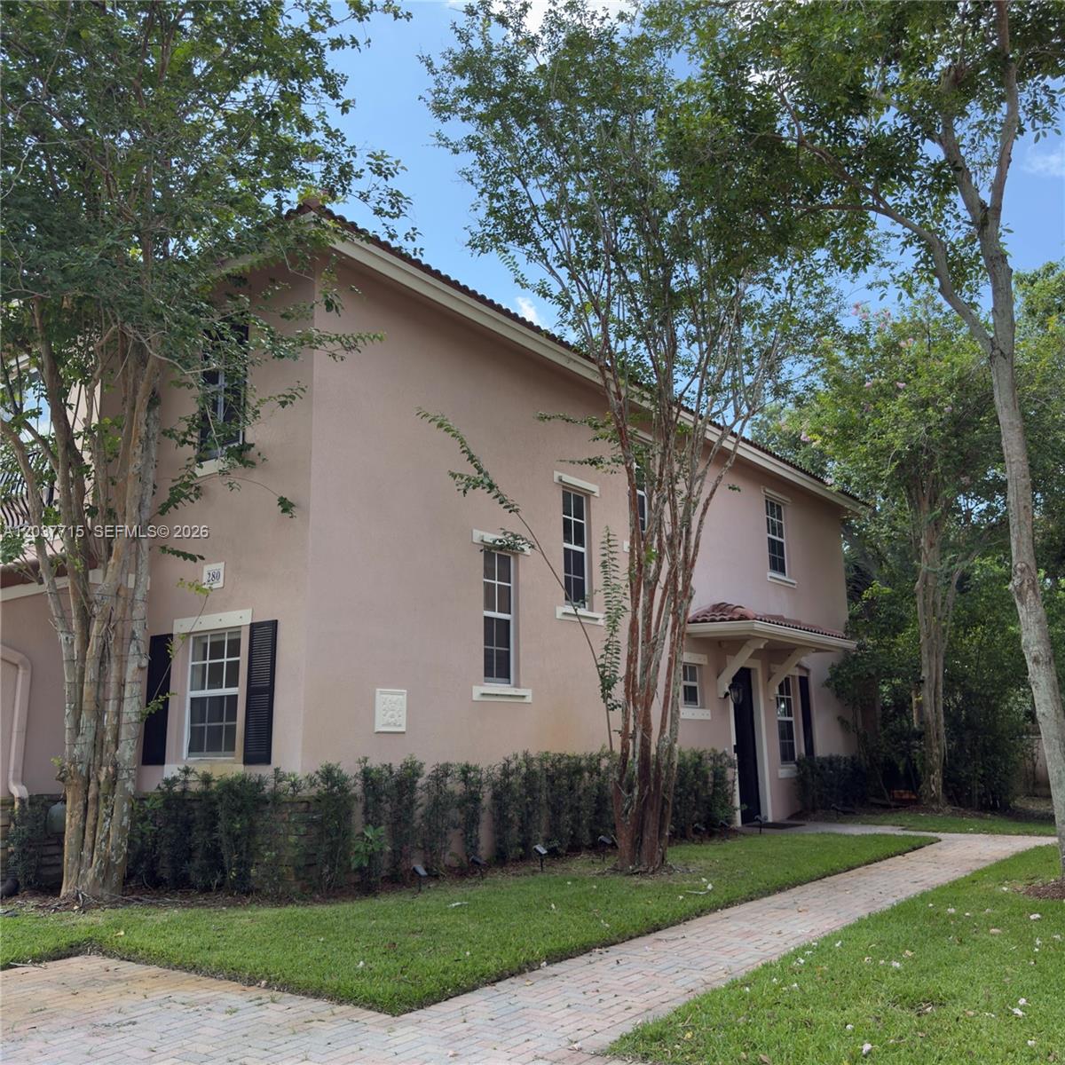 A two-story peach-colored house with a brick walkway and surrounding trees — 280 Las Brisas Cir # 280, Sunrise FL 33326, SUNRISE, FL