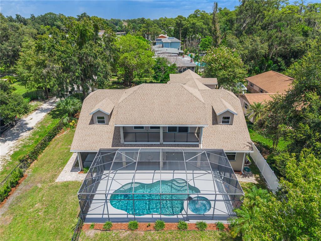 An aerial view of a two-story house with a screened-in pool and spa — 430 BYWATER DRIVE, ORLANDO, FL
