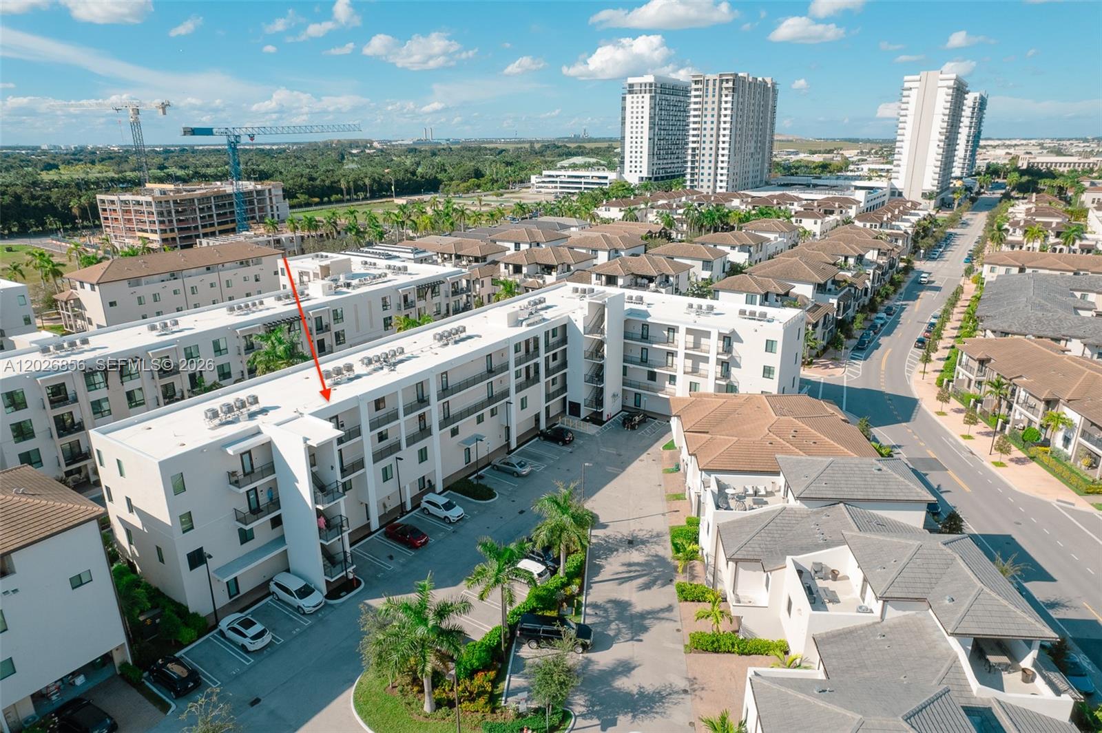 An aerial view shows a multi-story apartment building with balconies and an adjacent parking lot — 4745 NW 84th Ct # 47, Doral FL 33166, DORAL, FL