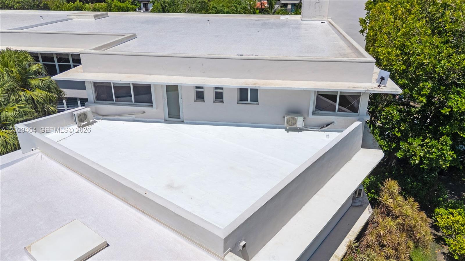 An aerial view shows the flat white roof of a multi-story building with air conditioning units — 10190 Collins Ave, Bal Harbour FL 33154, BAL HARBOUR, FL