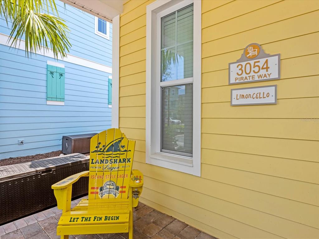 A bedroom features a light blue bed frame, tile flooring, and a door with blinds — 3054 PIRATE WAY, KISSIMMEE, FL