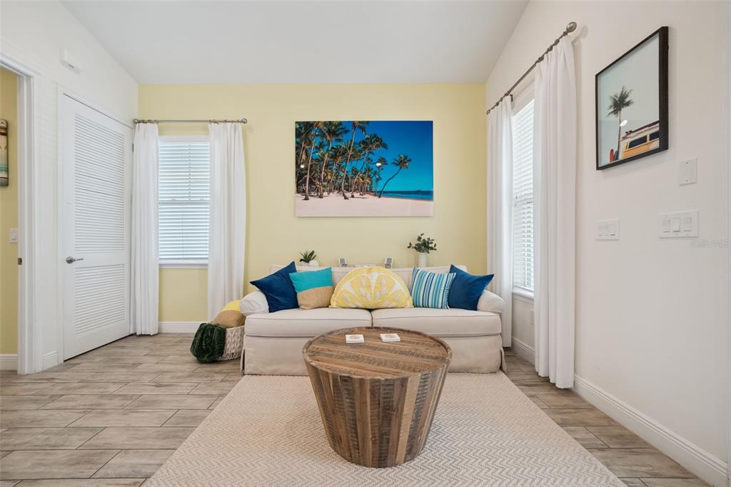 A small yellow building with a patio, lounge chairs, and a dining set outdoors — 3054 PIRATE WAY, KISSIMMEE, FL