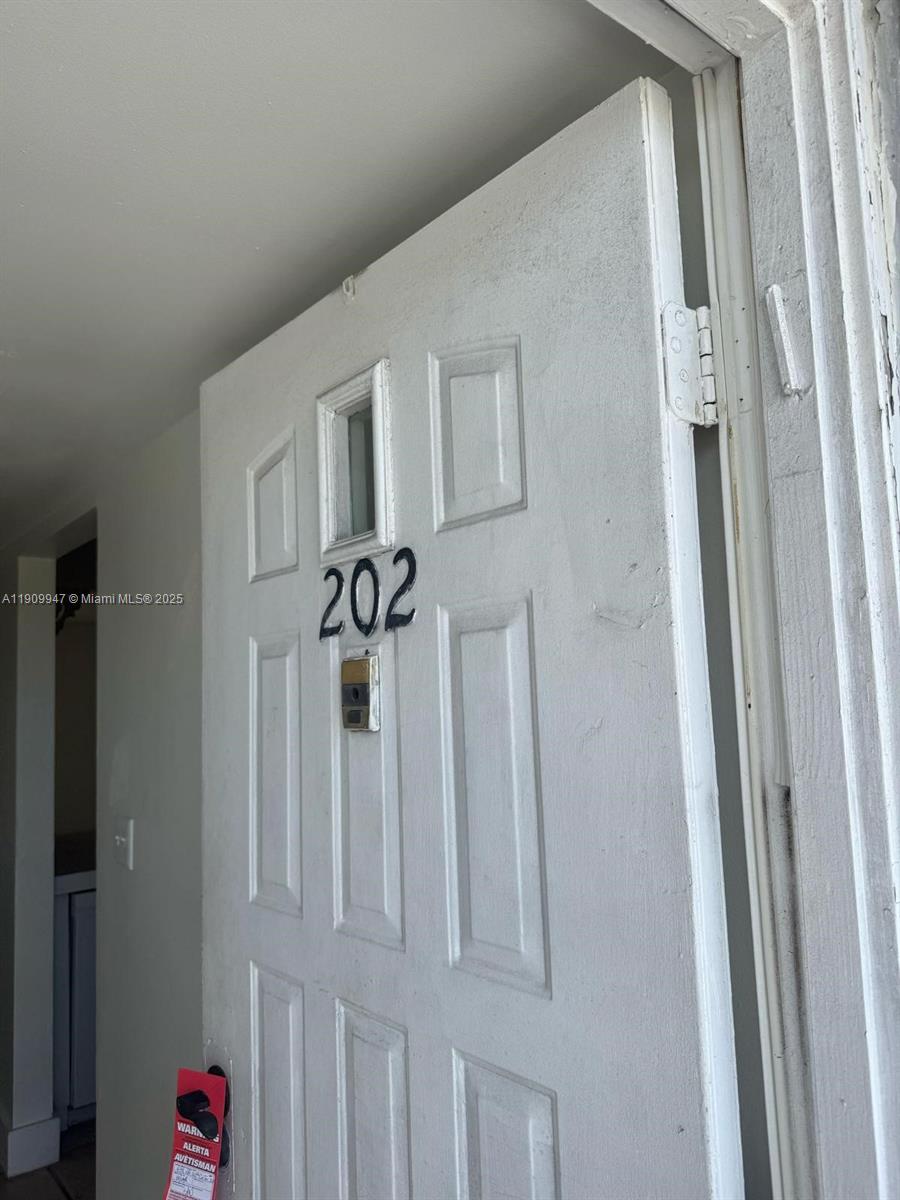 A white apartment door with the number 202 is shown from an interior hallway — 438 NE 210th Cir Ter # 4B, Miami FL 33179, MIAMI, FL