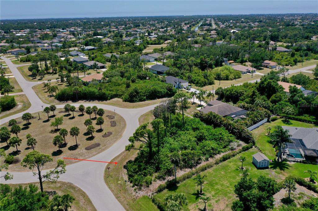 An aerial view shows a vacant residential lot next to a cul-de-sac and houses — 125 AUSTRALIAN DRIVE, ROTONDA WEST, FL