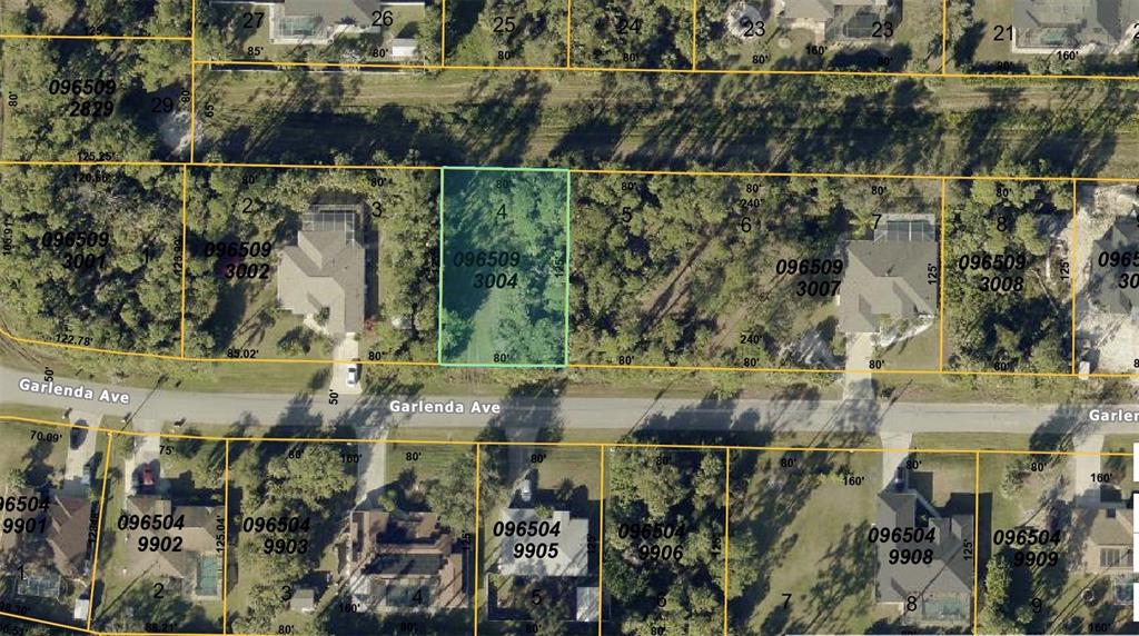 This is an aerial map showing a vacant residential lot highlighted in green — GARLENDA AVENUE, NORTH PORT, FL