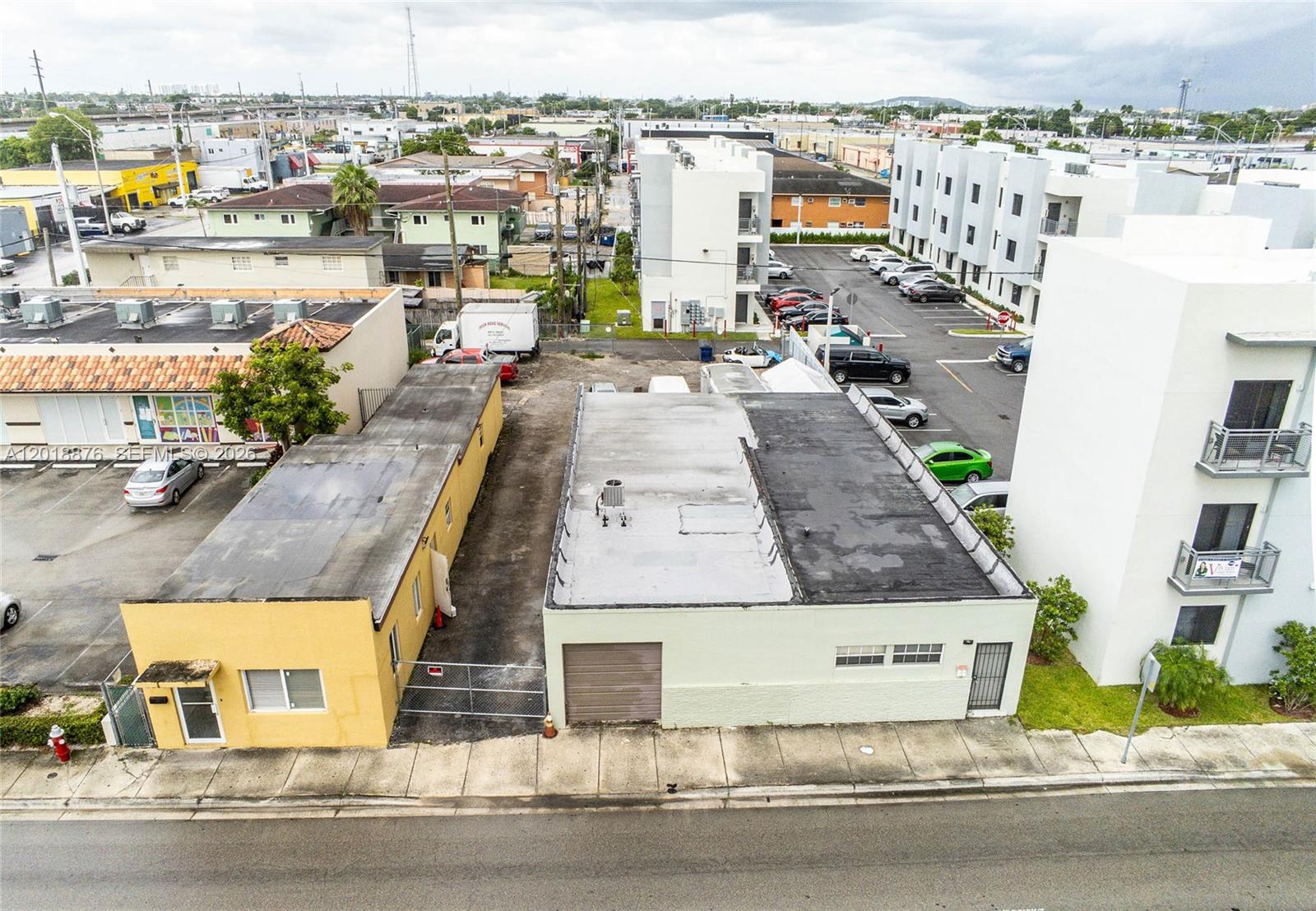 An aerial view shows two adjacent commercial buildings with flat roofs and a parking lot — 2250 Palm Ave, Hialeah FL 33010, HIALEAH, FL