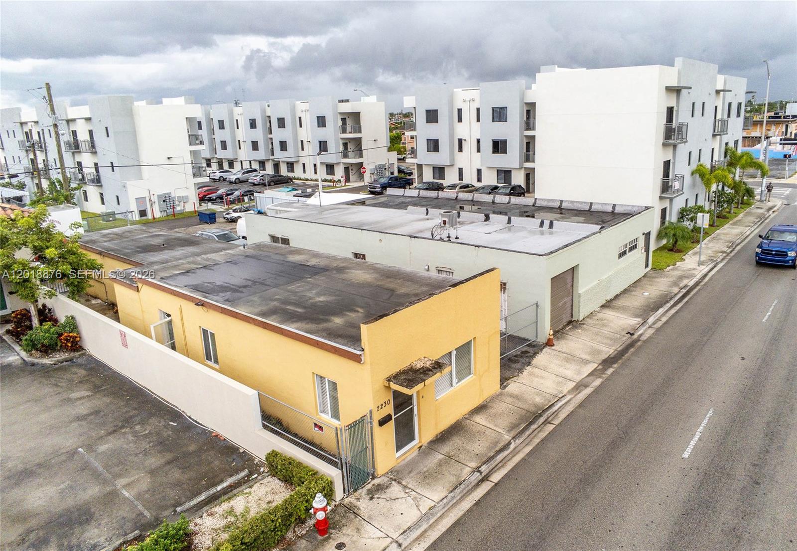 An aerial view shows a yellow commercial building next to a light green warehouse — 2250 Palm Ave, Hialeah FL 33010, HIALEAH, FL