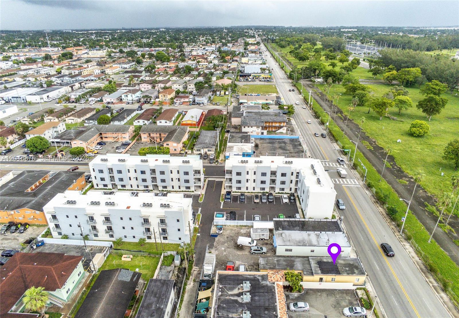 An aerial view shows apartment buildings, a parking lot, and a road with vehicles — 2250 Palm Ave, Hialeah FL 33010, HIALEAH, FL