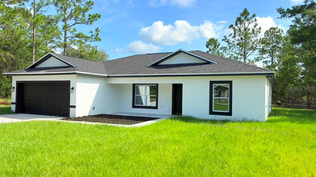 This is a floor plan of a single-story house with a garage and covered deck — 17 MALAUKA RUN DRIVE, OCKLAWAHA, FL
