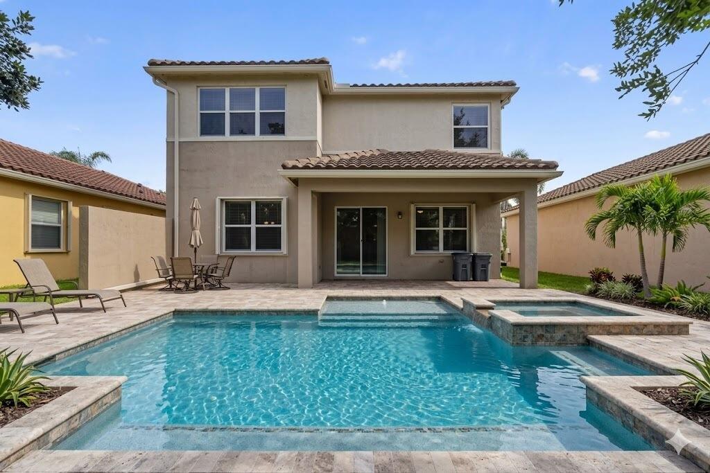 A two-story house with a backyard swimming pool, spa, and covered patio area — 8135 Cantabria Falls Drive, Boynton Beach FL 33473, BOYNTON BEACH, FL