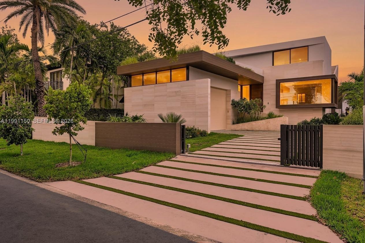 A modern two-story house with a stone facade, flat roof, and a paved driveway — 535 N Shore Dr, Miami Beach FL 33141, MIAMI BEACH, FL