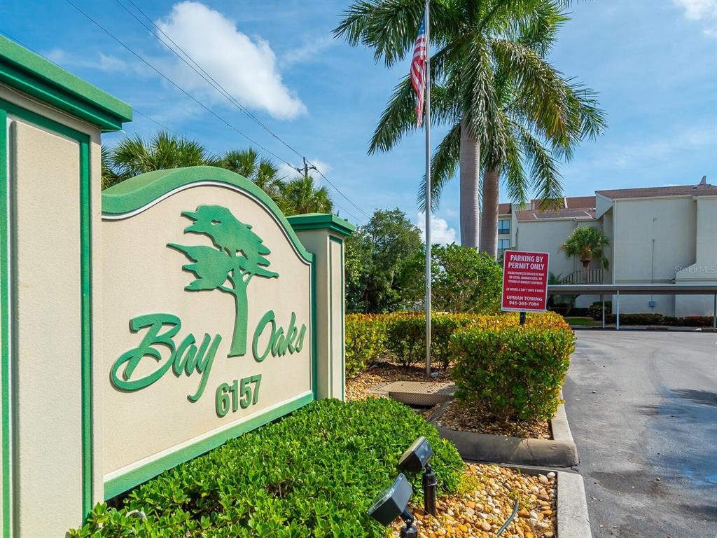 A kitchen with white cabinets, a blue tile backsplash, and stainless steel appliances — 6157 MIDNIGHT PASS ROAD UNIT E12, SARASOTA, FL