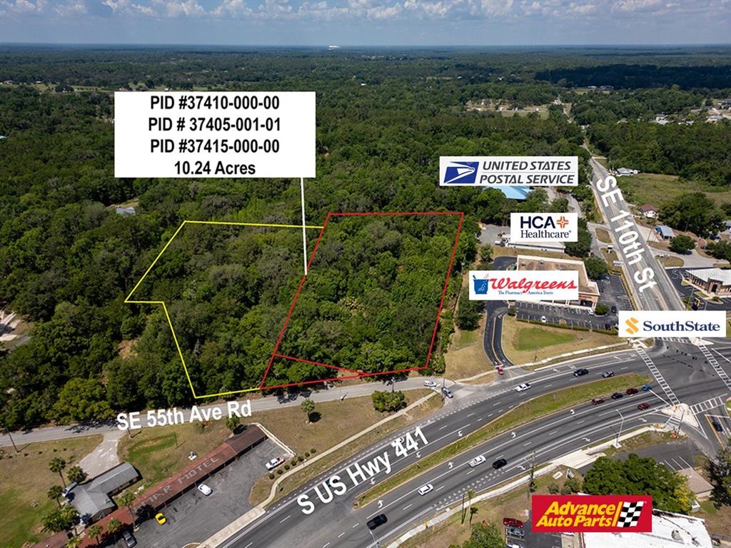 This aerial map shows a wooded 10.24-acre property outlined in yellow and red near commercial businesses — 11144 SE 55TH AVENUE ROAD, BELLEVIEW, FL