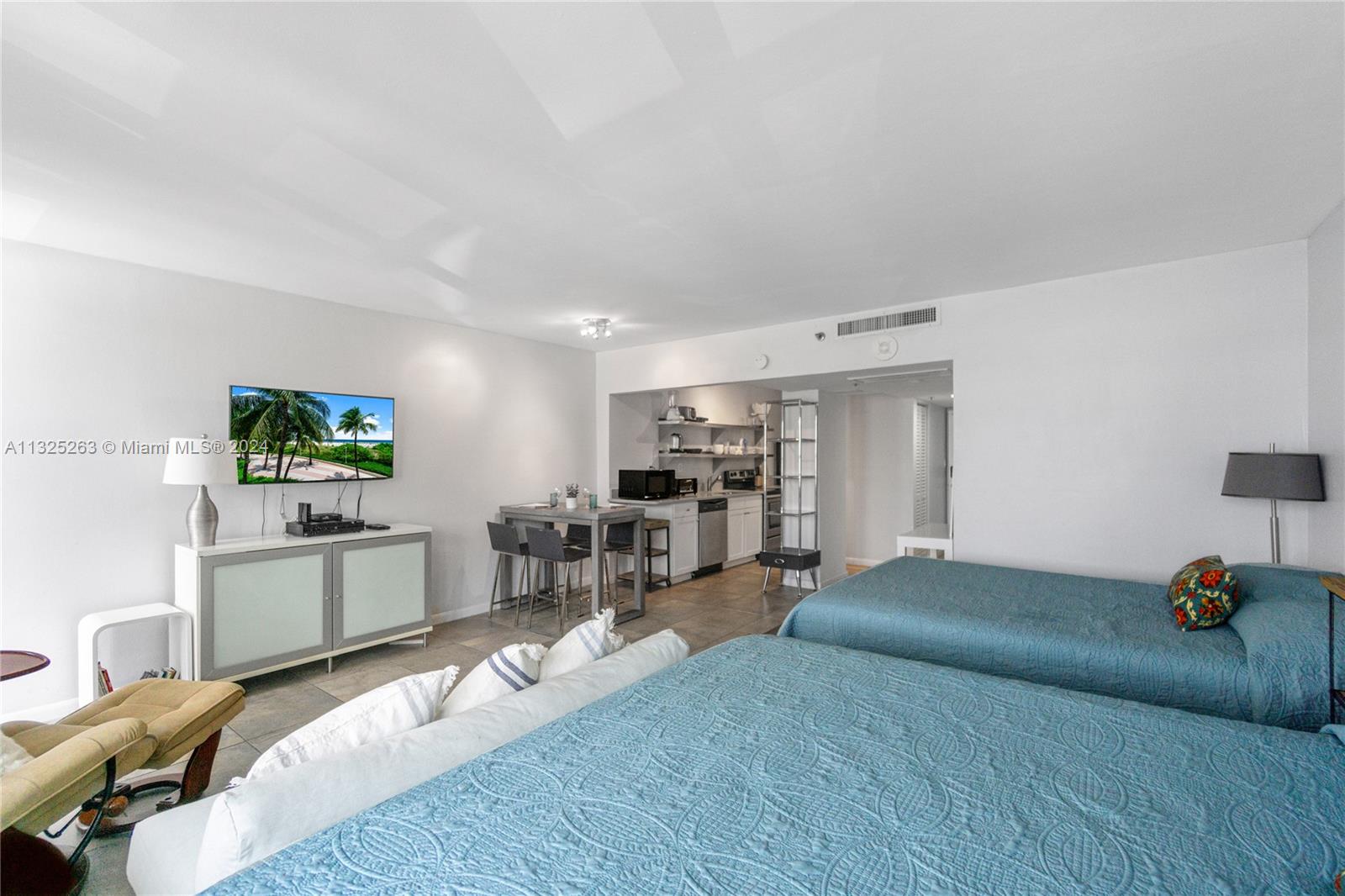 A studio apartment features two beds, a small dining area, and a compact kitchen — 100 Lincoln Rd # 320, Miami Beach FL 33139, MIAMI BEACH, FL