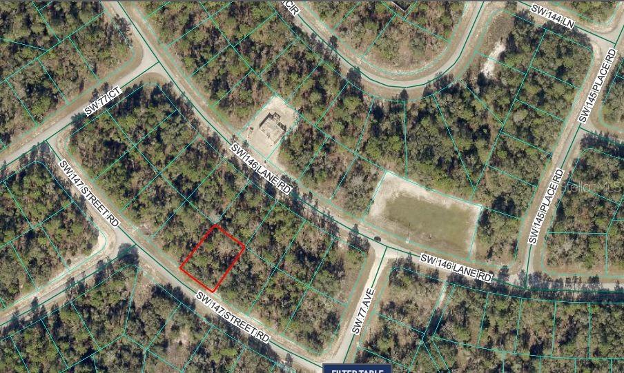An aerial map view shows a vacant, rectangular lot outlined in red within a wooded area — SW 147 STREET ROAD, OCALA, FL