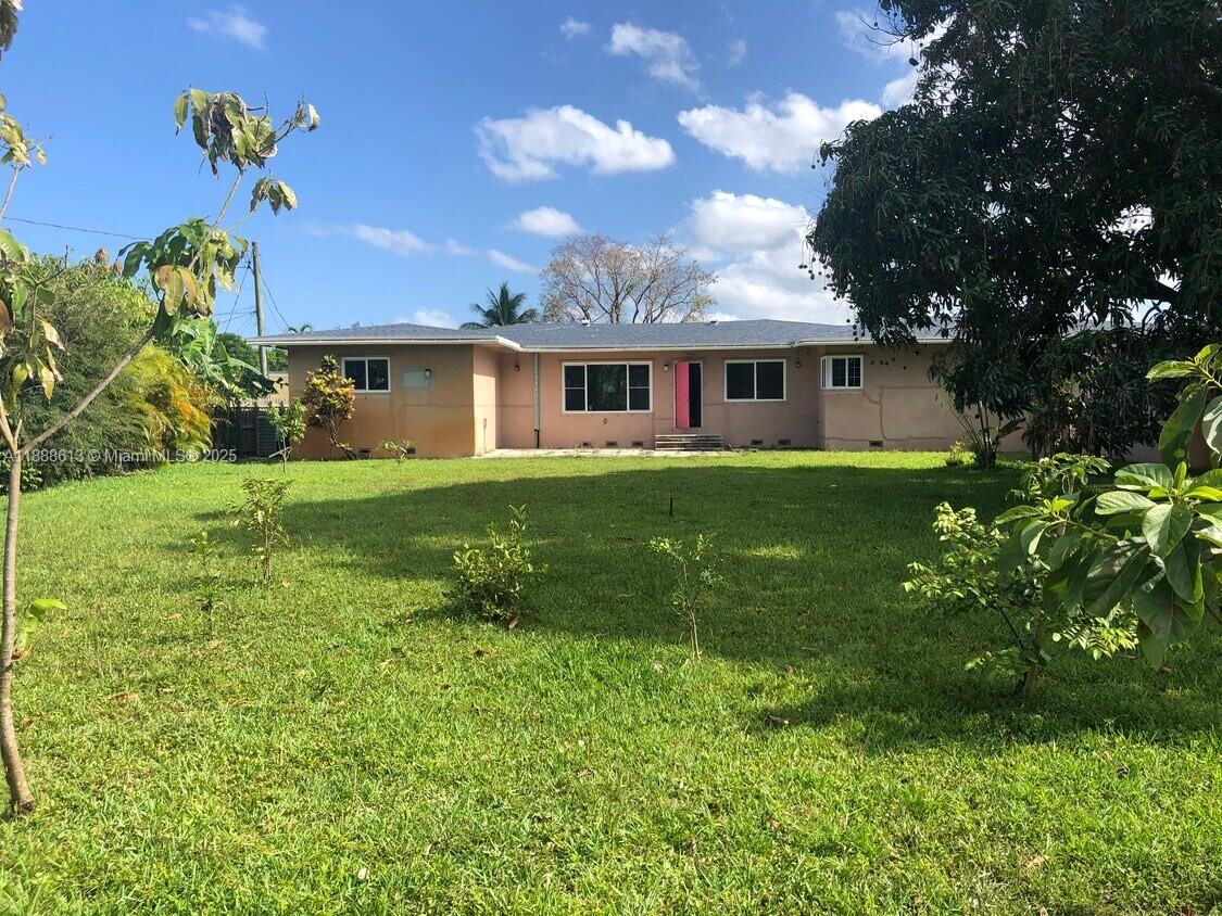 A single-story house with a tan exterior and a bright pink front door — 2815 Jackson St, Hollywood FL 33020, HOLLYWOOD, FL