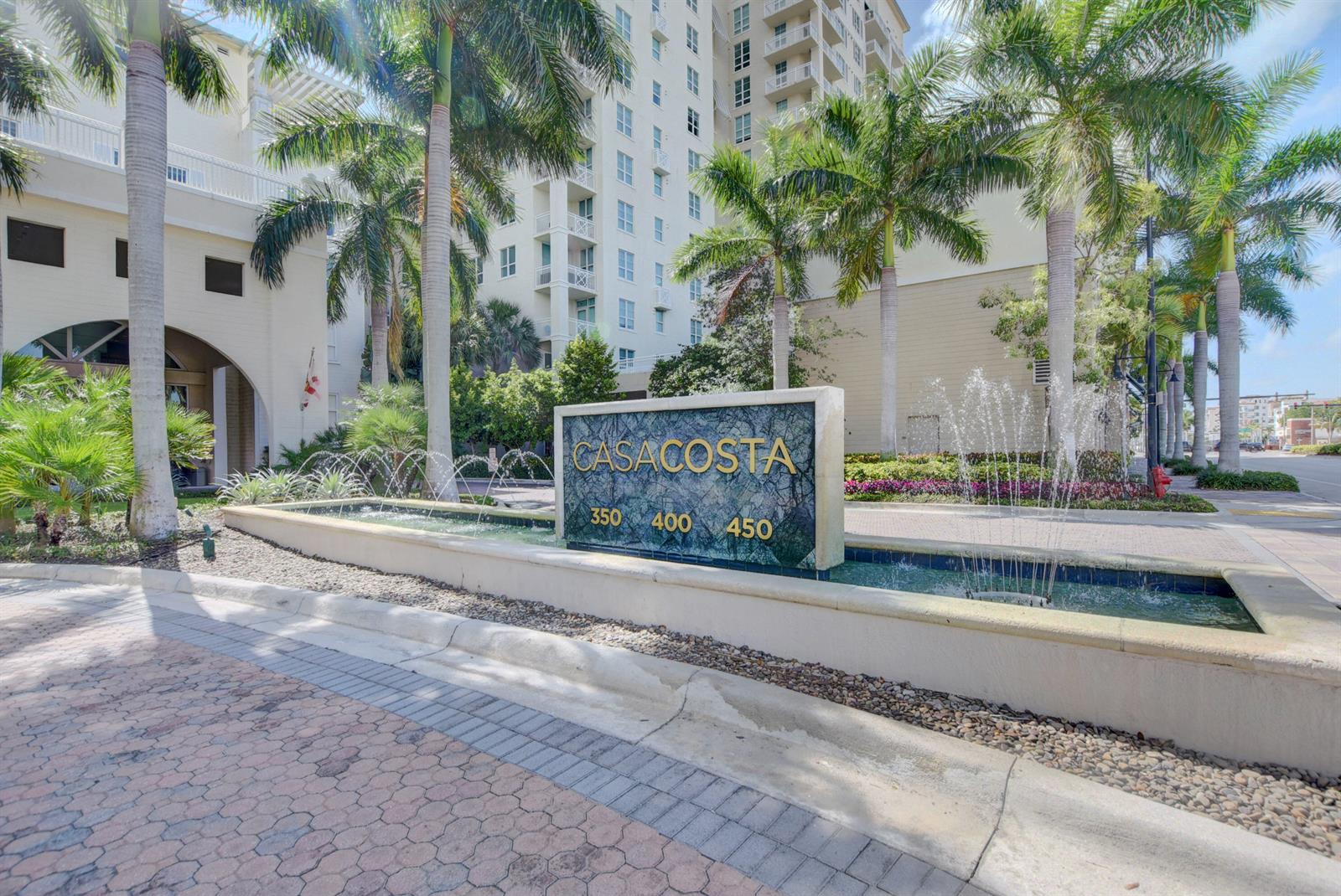 A stone monument sign for Casacosta stands before a fountain and a tall residential building — 450 N Federal Highway # 504, Boynton Beach FL 33435, BOYNTON BEACH, FL