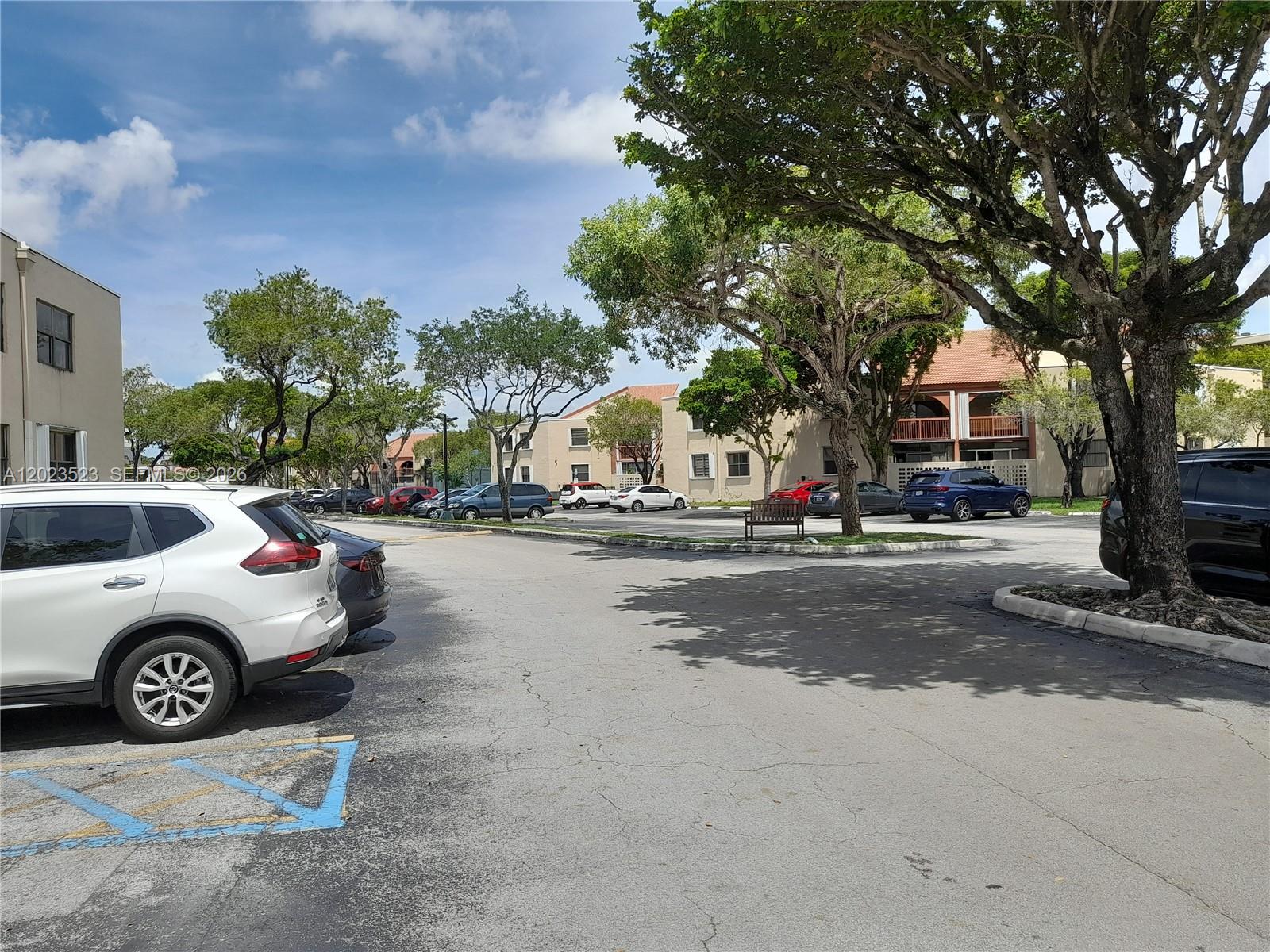 A parking lot with several parked cars sits in front of multi-story apartment buildings — 10245 NW 9th St Cir # 9, Miami FL 33172, MIAMI, FL
