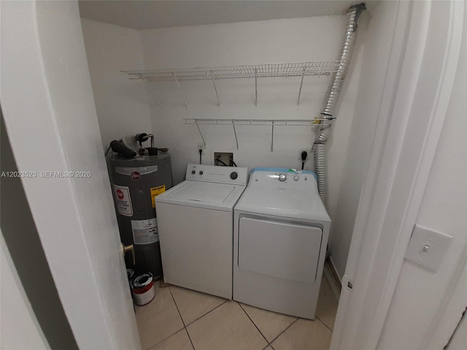 A laundry closet contains a water heater, a washing machine, and a dryer — 10245 NW 9th St Cir # 9, Miami FL 33172, MIAMI, FL