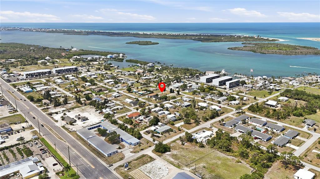 An aerial view shows a residential neighborhood near a coastal waterway with a red location marker — 3161 BOURBON STREET, ENGLEWOOD, FL