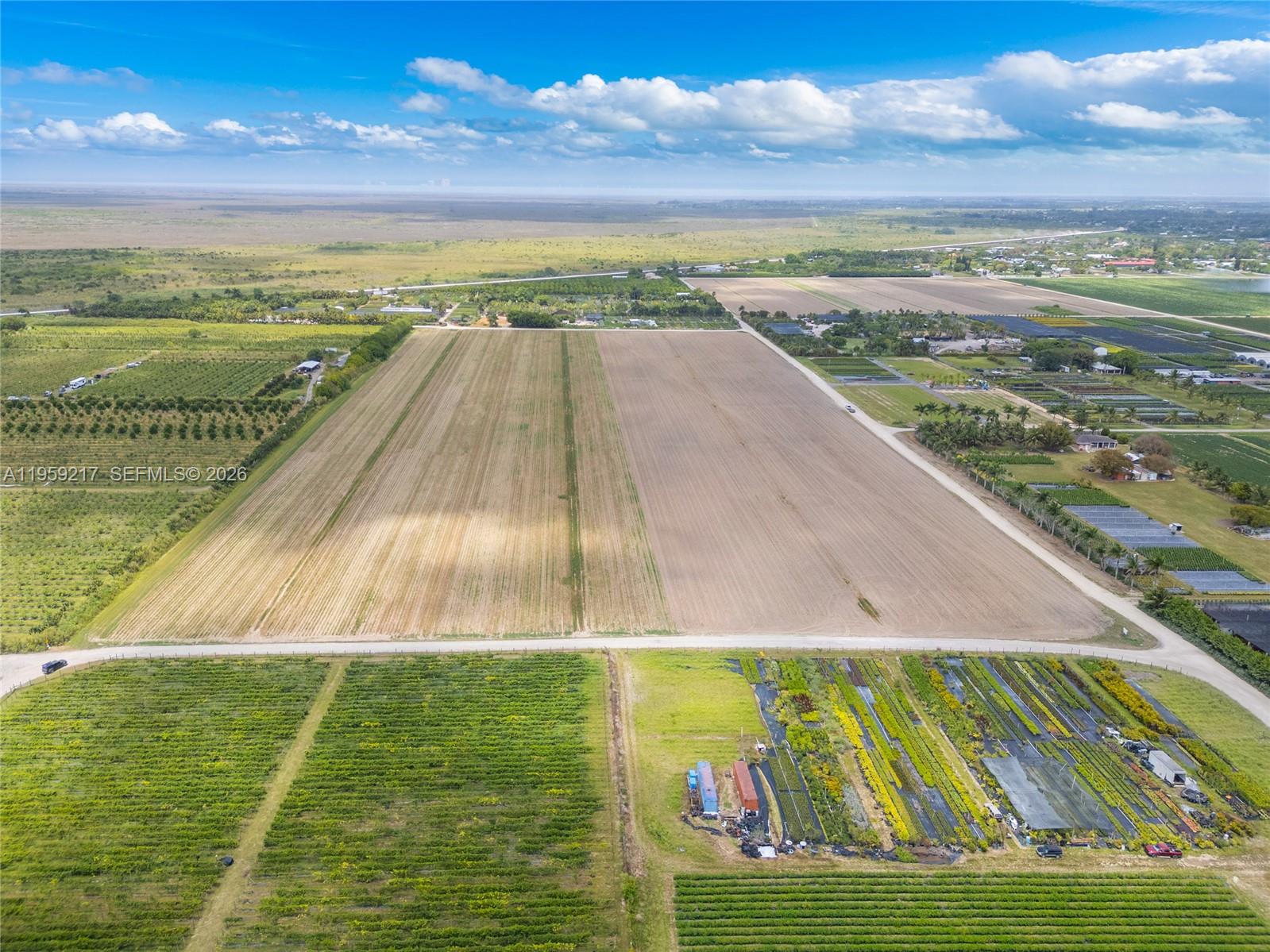 An aerial view shows a large, rectangular agricultural field bordered by smaller crop plots — 224XX sw 217ave, Miami FL 33170, MIAMI, FL