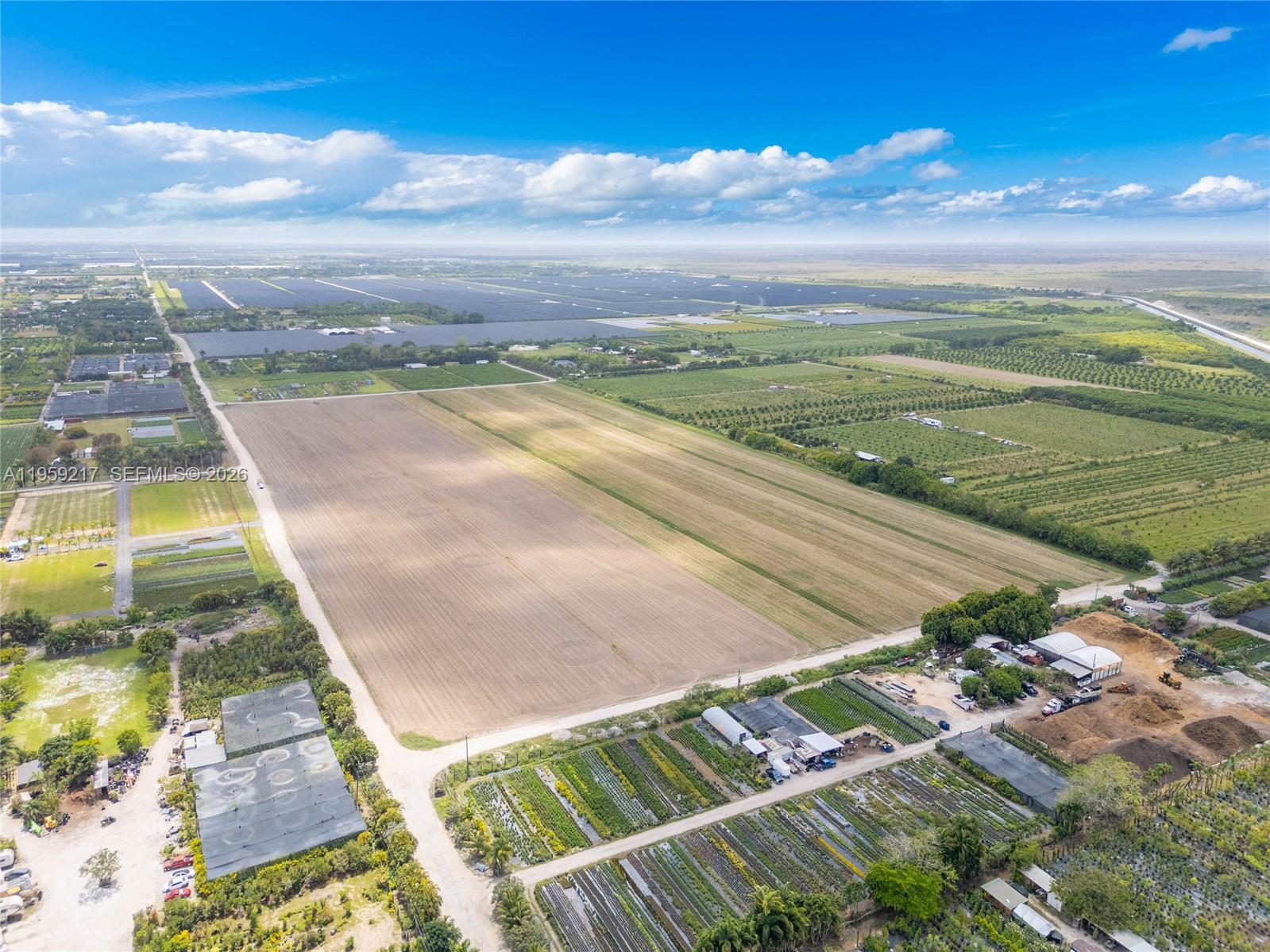 An aerial view shows a large agricultural property with fields, greenhouses, and nursery rows — 224XX sw 217ave, Miami FL 33170, MIAMI, FL
