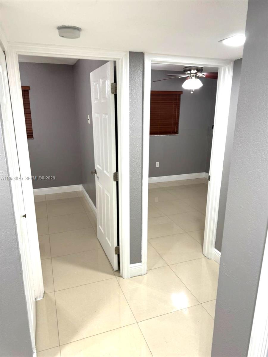 Two doorways open into rooms with gray walls, white trim, and light-colored tile flooring — 5461 W 24th Ave # 25, Hialeah FL 33016, HIALEAH, FL