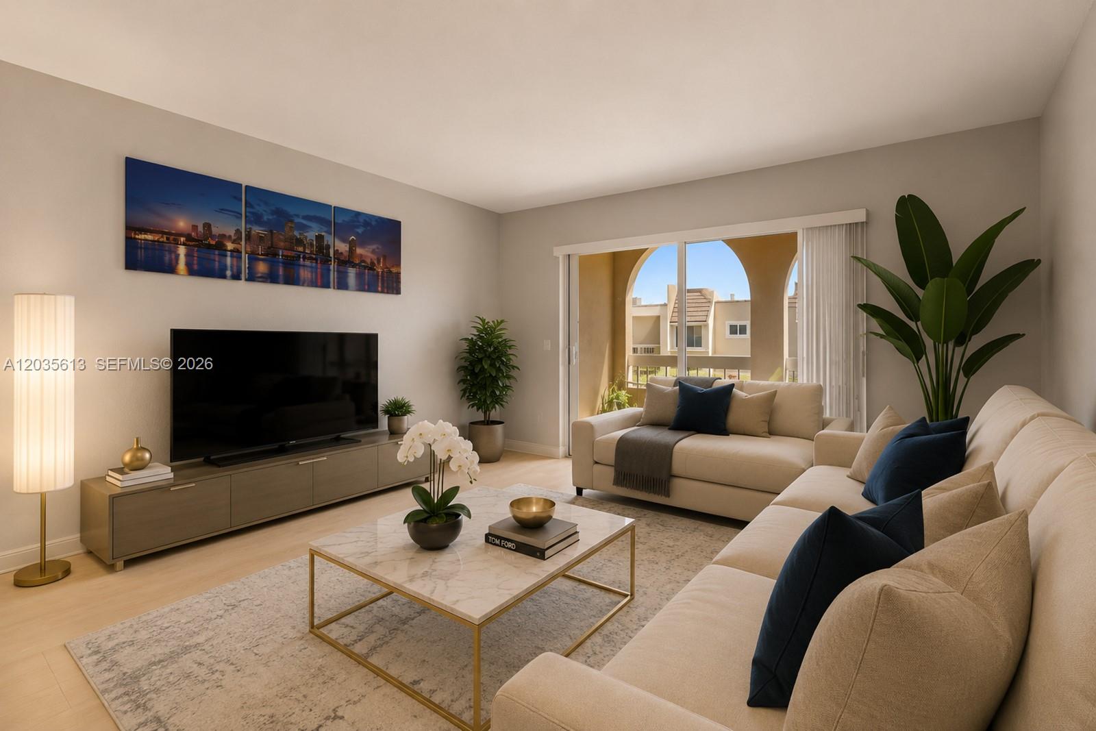 This living room features a beige sectional sofa, a marble coffee table, and a television — 7845 Camino Real # 413, Miami FL 33143, MIAMI, FL