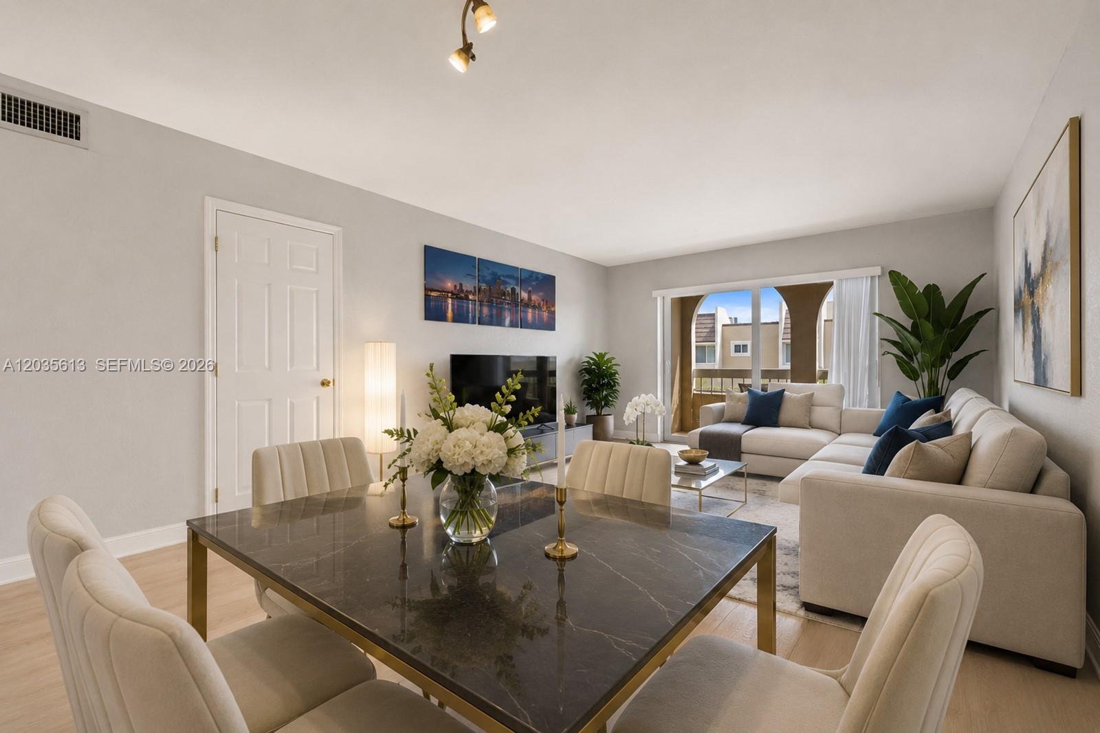 A living and dining area features a marble table, neutral furniture, and a balcony view — 7845 Camino Real # 413, Miami FL 33143, MIAMI, FL