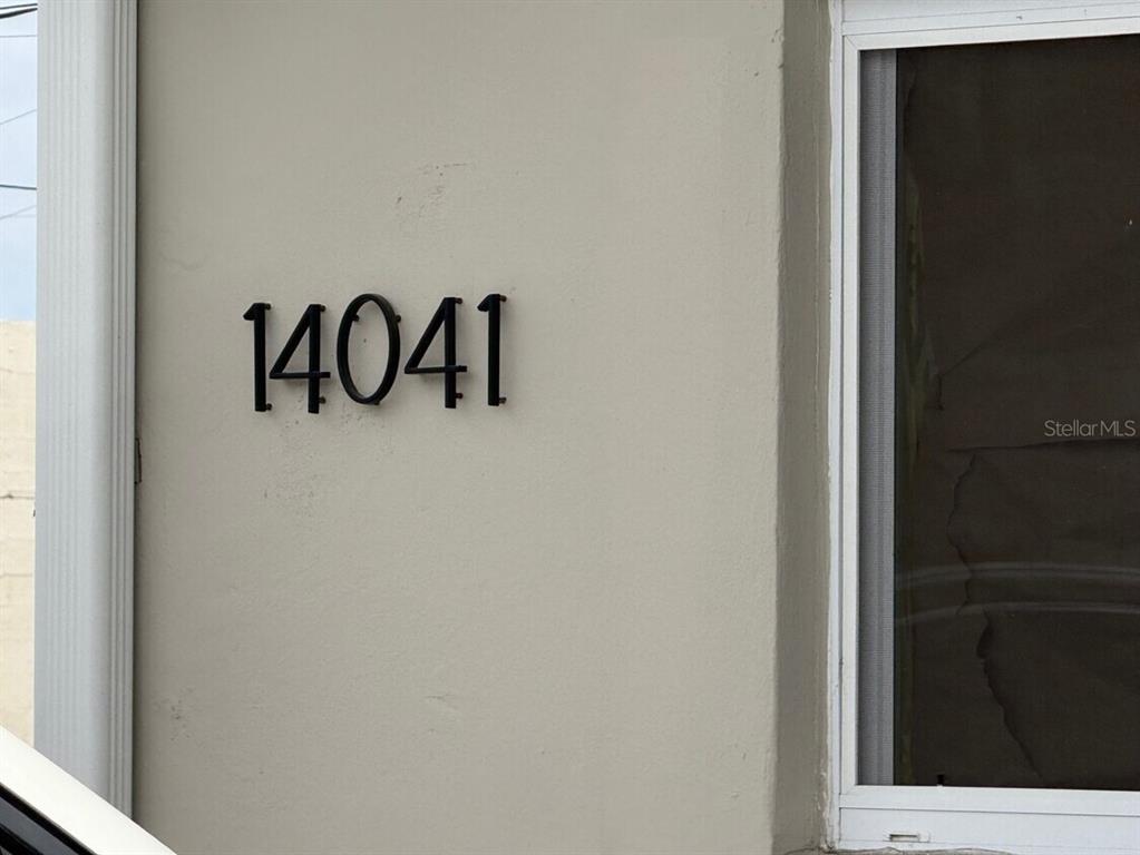 The house number 14041 is mounted on the exterior wall next to a window — 14040 NW 19TH AVENUE, OPA LOCKA, FL