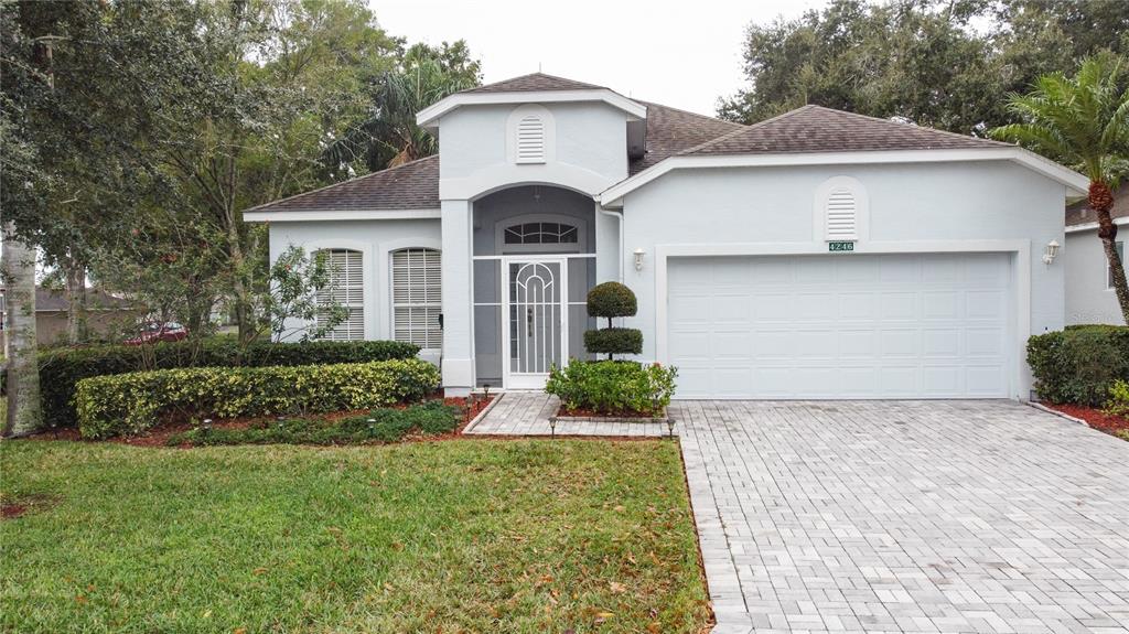 A single-story house with a light blue stucco exterior, a paved driveway, and a garage — 4246 NEWLAND STREET, CLERMONT, FL