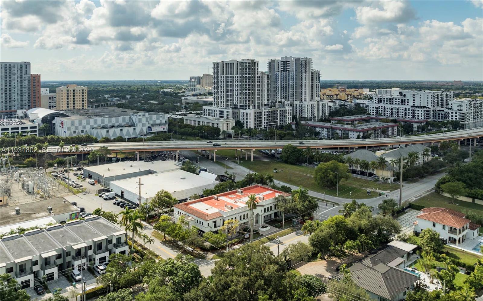 An aerial view shows a suburban neighborhood with a highway, apartment buildings, and commercial structures — 6900 SW 80th St, Miami FL 33143, MIAMI, FL