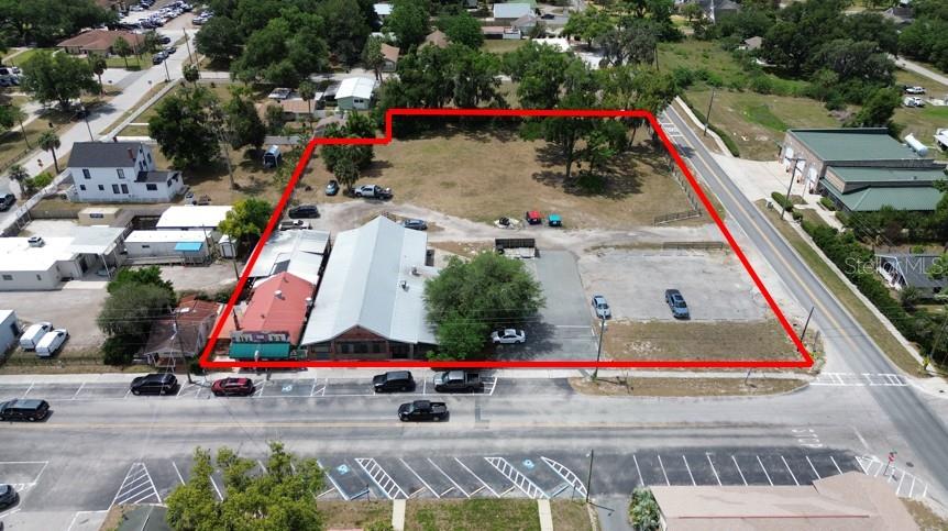 An aerial view shows a commercial property with buildings and a parking lot outlined in red — 32750 PENNSYLVANIA AVENUE, SAN ANTONIO, FL