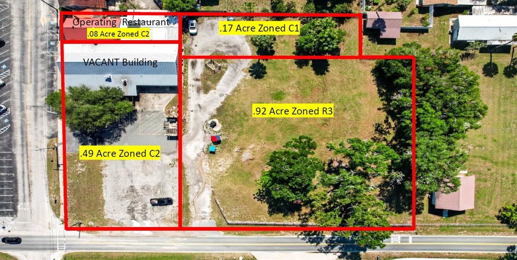 This aerial view shows a land parcel with multiple buildings and designated zoning areas — 32750 PENNSYLVANIA AVENUE, SAN ANTONIO, FL