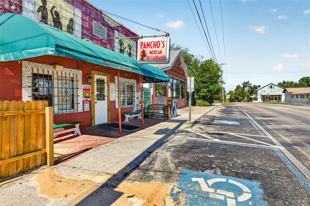 The exterior of a Mexican restaurant features a green awning, a sign, and parking spaces — 32750 PENNSYLVANIA AVENUE, SAN ANTONIO, FL