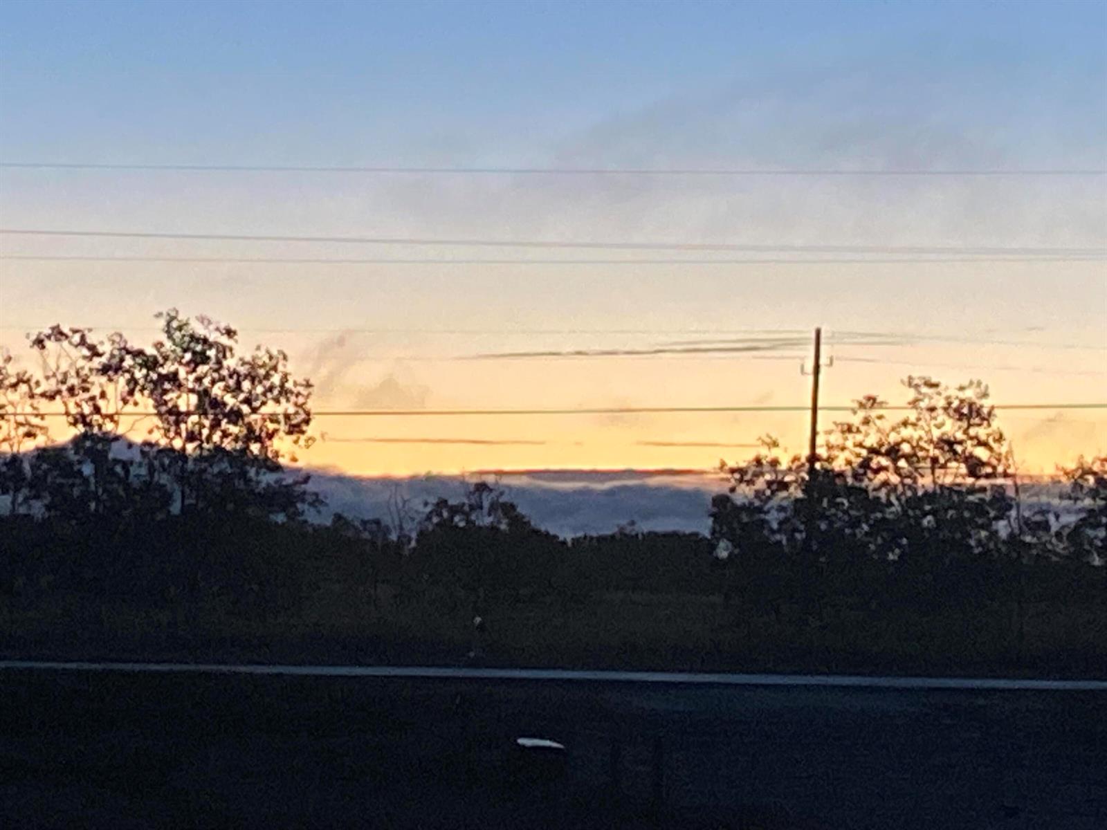 A view of a sunset over a treeline with power lines visible in the foreground — 1425 S Header Canal Road, Fort Pierce FL 34945, FORT PIERCE, FL