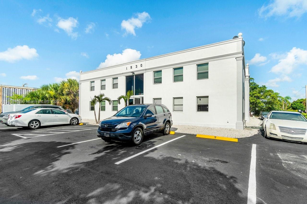 A two-story white commercial building with a parking lot in front — 1530 Crescent Cir, West Palm Beach FL 33403, WEST PALM BEACH, FL
